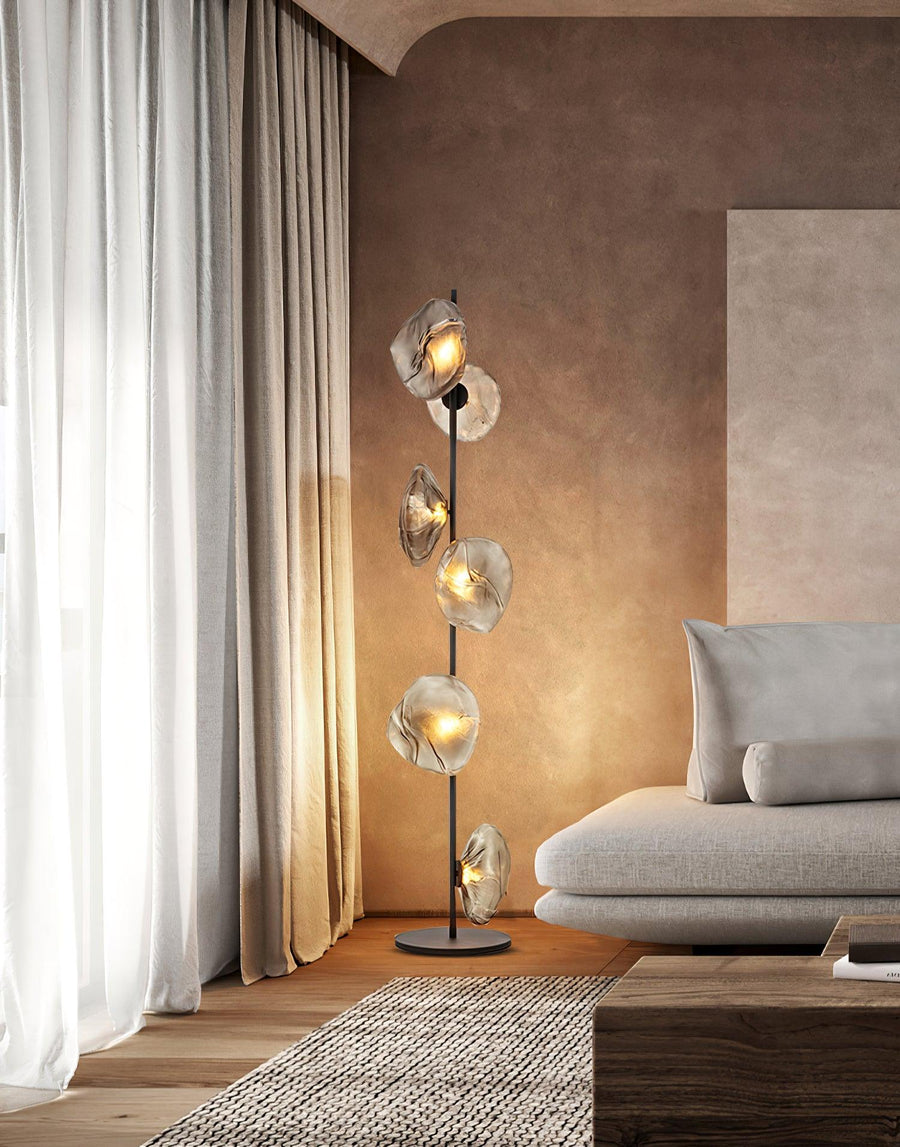 Aether Bloom Floor Lamp with handcrafted smoked glass petal shades arranged along a minimalist black metal frame, creating sculptural ambient lighting for luxury interiors.