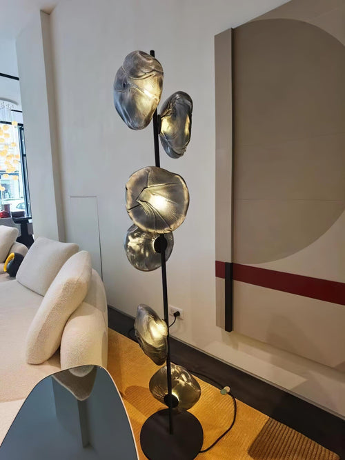 Aether Bloom Floor Lamp with handcrafted smoked glass petal shades arranged along a minimalist black metal frame, creating sculptural ambient lighting for luxury interiors.