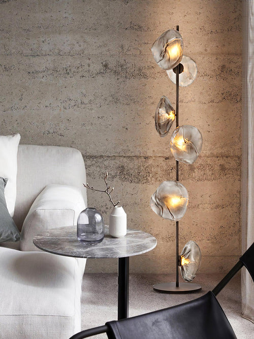 Aether Bloom Floor Lamp with handcrafted smoked glass petal shades arranged along a minimalist black metal frame, creating sculptural ambient lighting for luxury interiors.