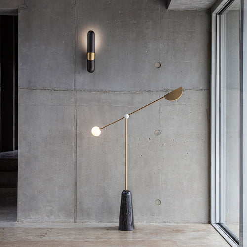 Alonzo Floor Lamp featuring a sculptural brass frame, frosted glass globe, directional metal reflector, and luxurious marble base, designed for contemporary luxury interiors