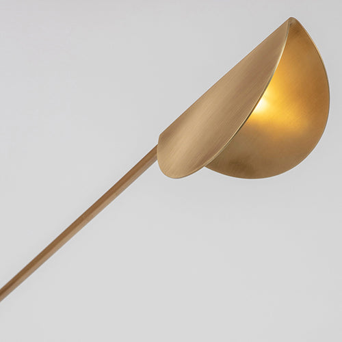 Alonzo Floor Lamp featuring a sculptural brass frame, frosted glass globe, directional metal reflector, and luxurious marble base, designed for contemporary luxury interiors