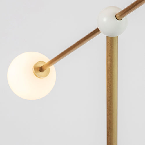 Alonzo Floor Lamp featuring a sculptural brass frame, frosted glass globe, directional metal reflector, and luxurious marble base, designed for contemporary luxury interiors