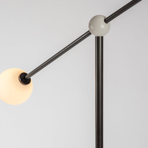 Alonzo Floor Lamp featuring a sculptural brass frame, frosted glass globe, directional metal reflector, and luxurious marble base, designed for contemporary luxury interiors