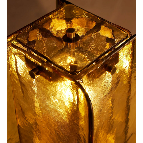 Ambra Table Lamp featuring handcrafted amber glass panels and a sculptural metal base, a luxury Art Deco-inspired lighting piece for sophisticated interiors