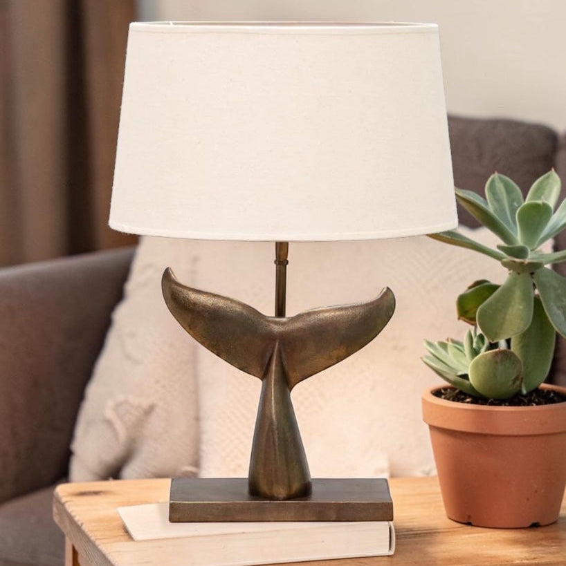 Sculptural table lamp with whale tail base