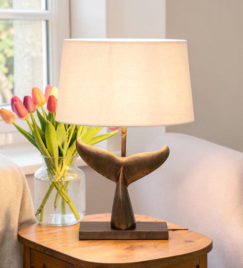 Sculptural table lamp with whale tail base