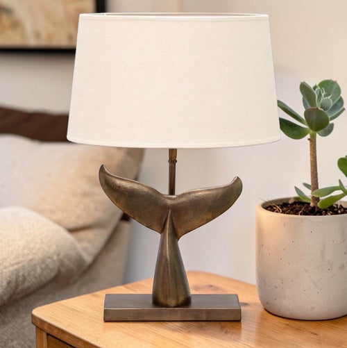 Sculptural table lamp with whale tail base