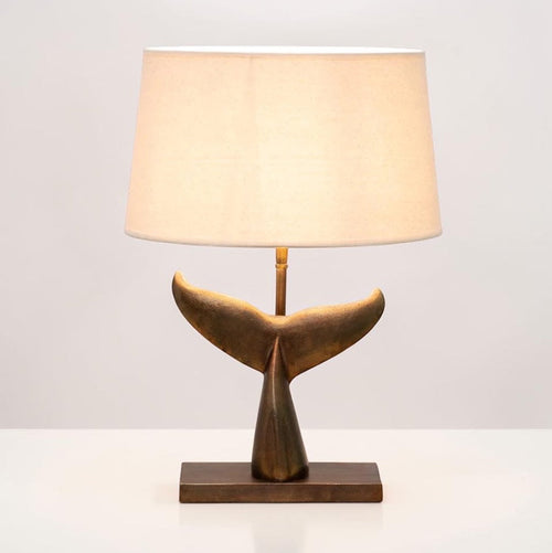 Sculptural table lamp with whale tail base