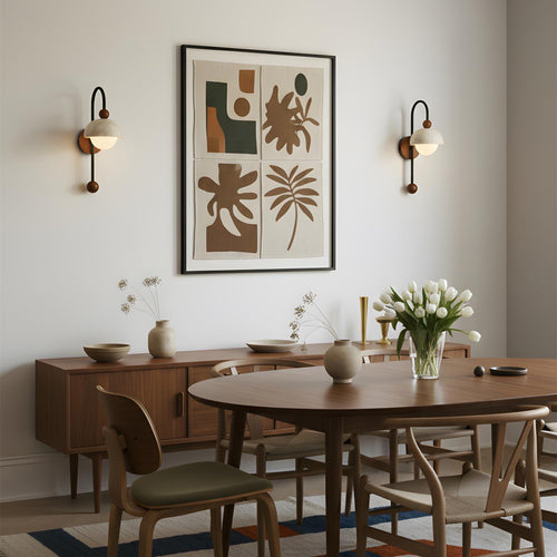 Dining room with wooden table, chairs, and abstract art on the wall.