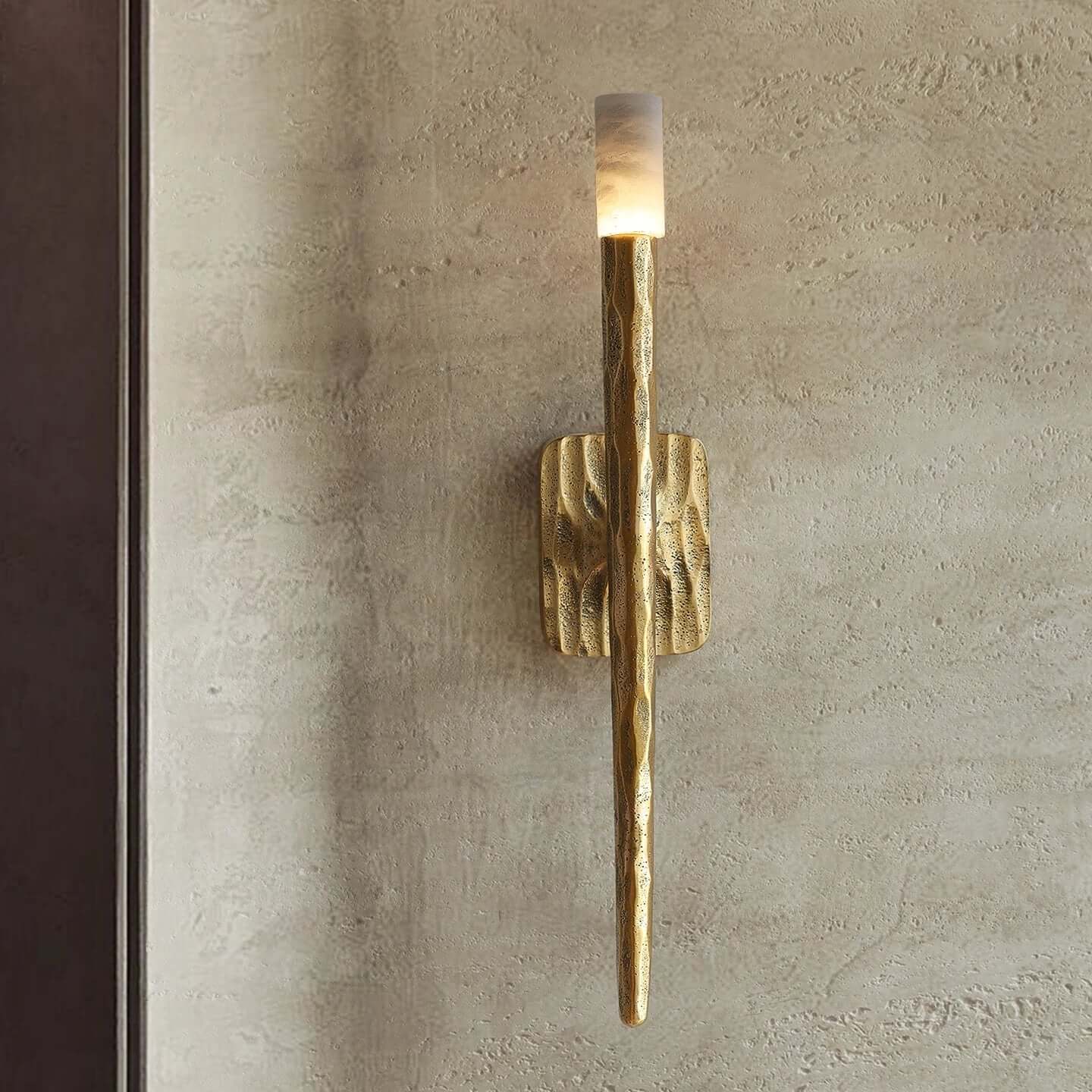 Atelier Sconce crafted from hand-forged brass and natural marble, a luxury wall light featuring sculptural texture and warm ambient illumination