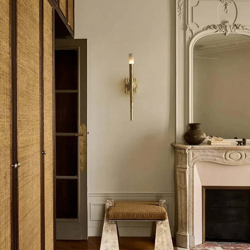 Atelier Sconce crafted from hand-forged brass and natural marble, a luxury wall light featuring sculptural texture and warm ambient illumination