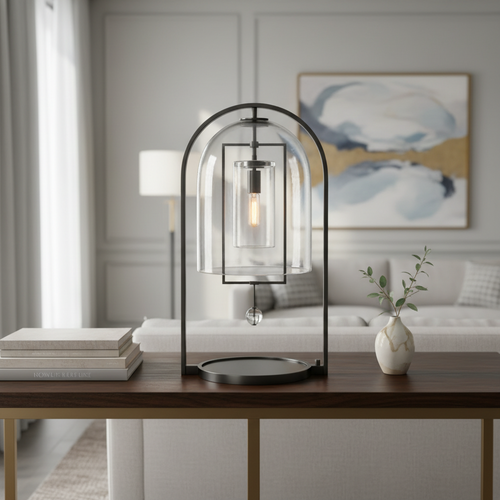 Aurelies Table Lamp featuring a clear glass lantern shade suspended within a brass frame, a luxury designer table lamp for contemporary and Mid-Century inspired interiors