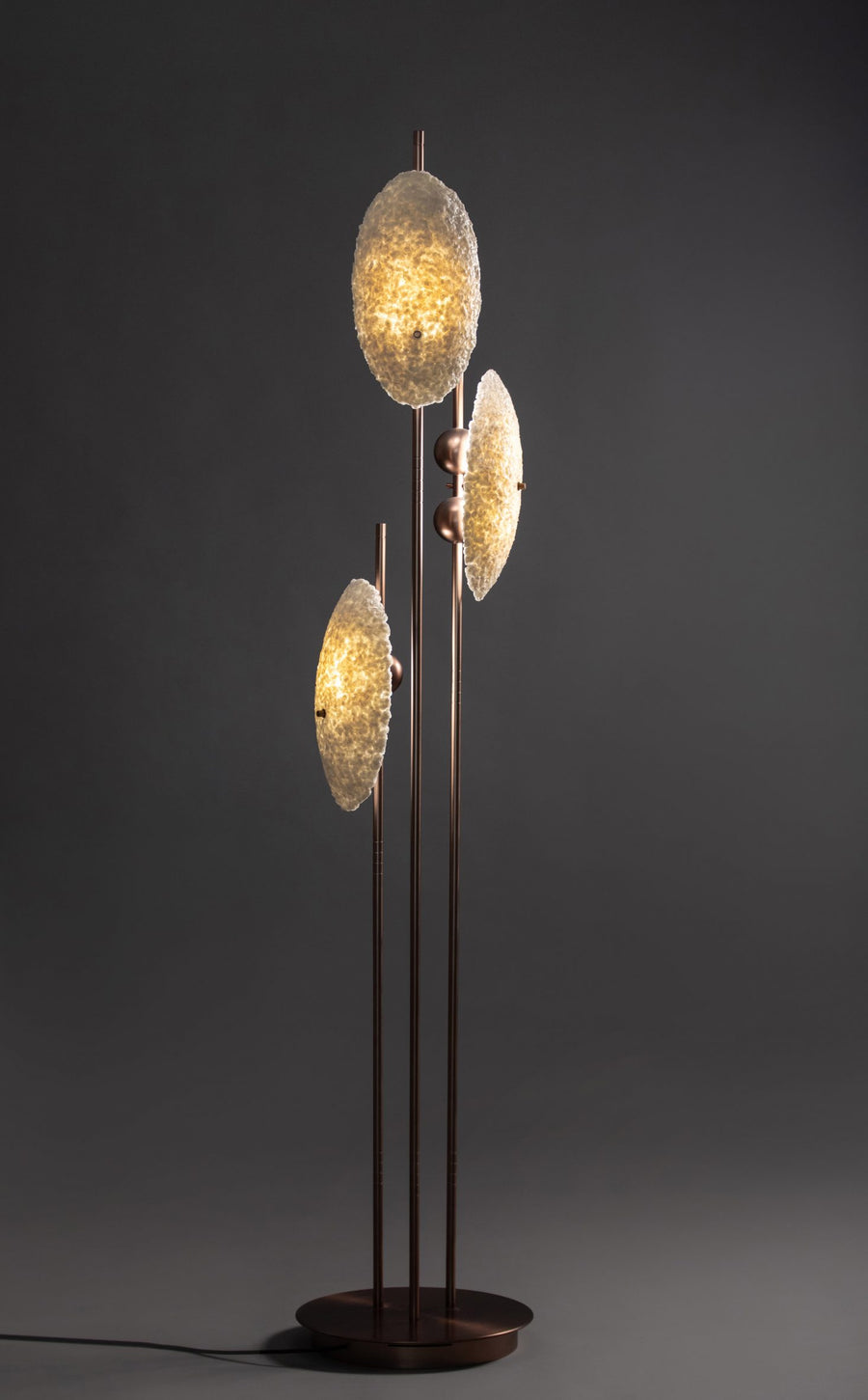Comet Floor Lamp featuring three textured illuminated discs mounted on slender brushed brass stems, creating a sculptural luxury lighting statement for contemporary interiors