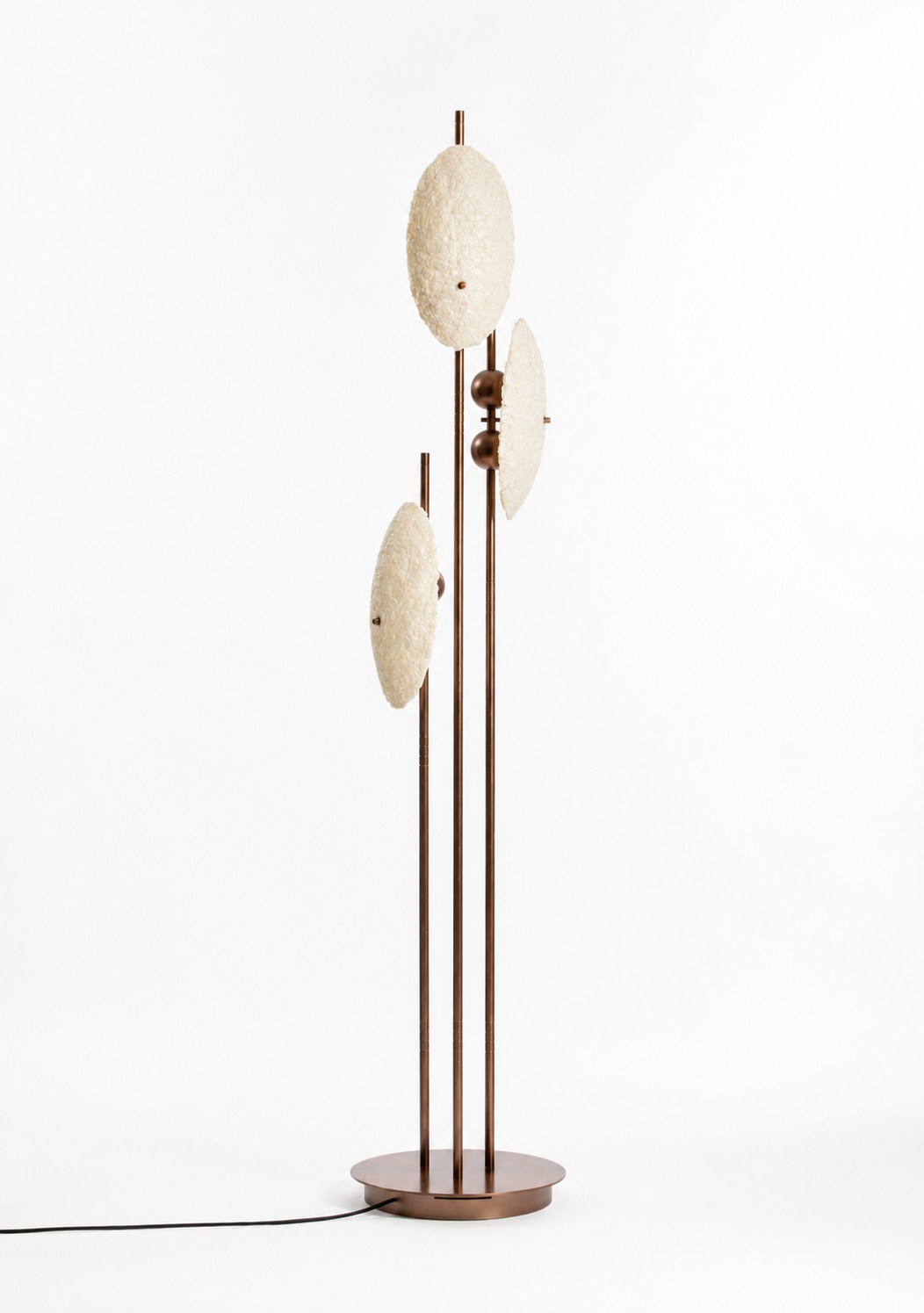 Comet Floor Lamp featuring three textured illuminated discs mounted on slender brushed brass stems, creating a sculptural luxury lighting statement for contemporary interiors