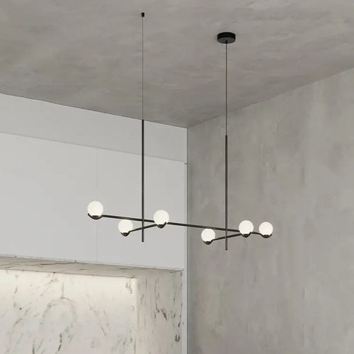 Modern brass linear chandelier with globe lights