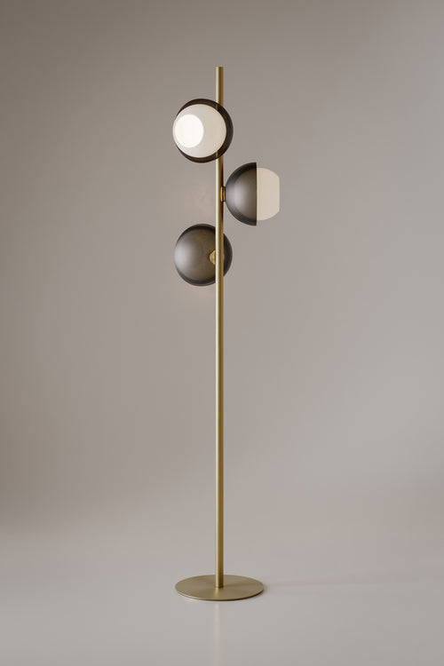Evo Floor Lamp featuring illuminated frosted glass discs and a sculptural brass frame, designed as a contemporary statement lighting piece for luxury interiors