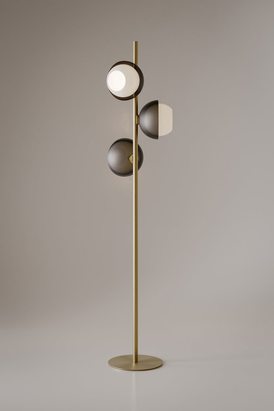 Evo Floor Lamp featuring illuminated frosted glass discs and a sculptural brass frame, designed as a contemporary statement lighting piece for luxury interiors