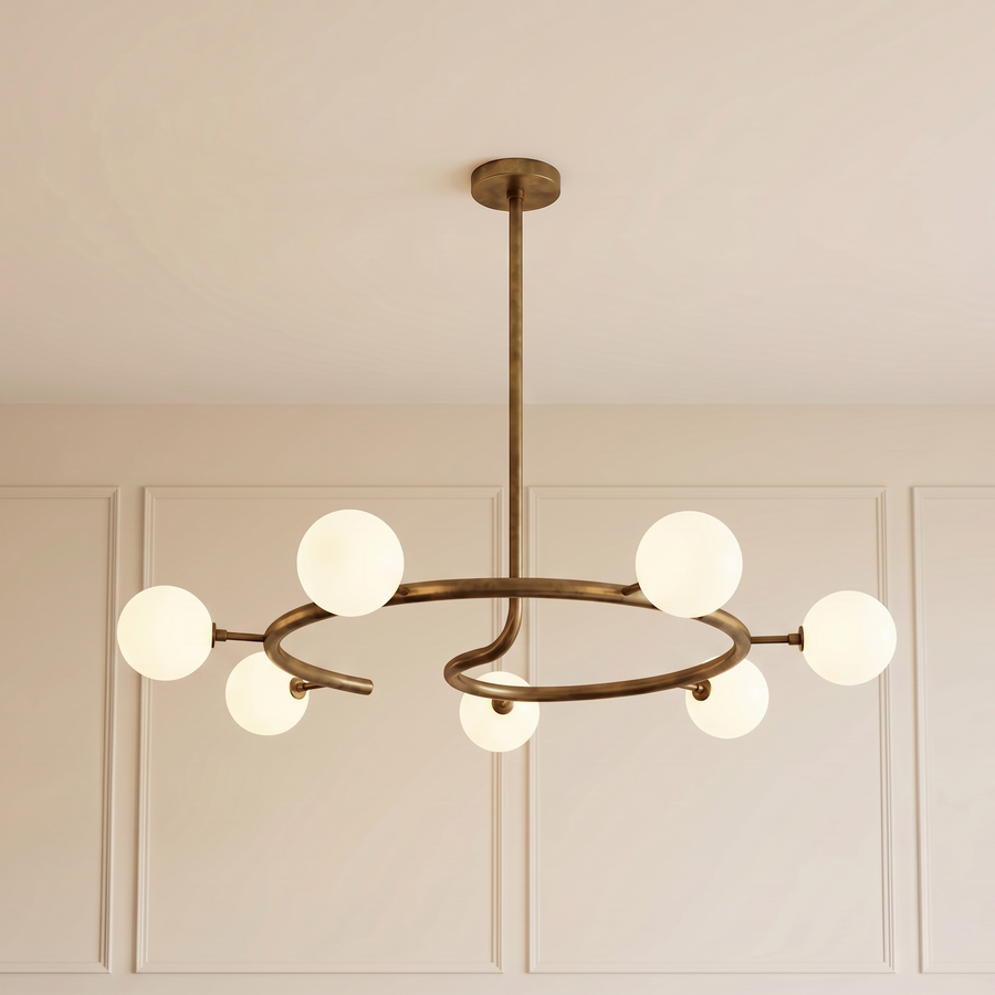 Helix Halo Chandelier with a sculptural brushed brass circular frame and seven matte milk glass globes, creating elegant ambient lighting for contemporary luxury interiors