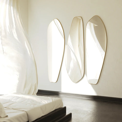 Irregular gold full length mirror mounted on wall in modern interior