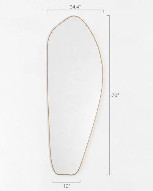 Irregular gold full length mirror mounted on wall in modern interior