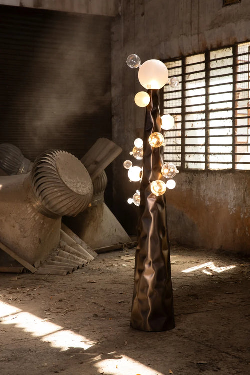 Molecule Floor Lamp featuring hand-blown glass spheres arranged around a sculptural matte gunmetal column, a luxury statement lighting piece for contemporary interiors.