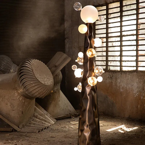 Molecule Floor Lamp featuring hand-blown glass spheres arranged around a sculptural matte gunmetal column, a luxury statement lighting piece for contemporary interiors.