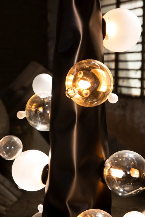 Molecule Floor Lamp featuring hand-blown glass spheres arranged around a sculptural matte gunmetal column, a luxury statement lighting piece for contemporary interiors.