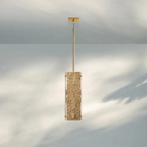 Monolith Pendant featuring a sculptural textured body with metallic detailing, a luxury Brutalist hanging light for modern interiors