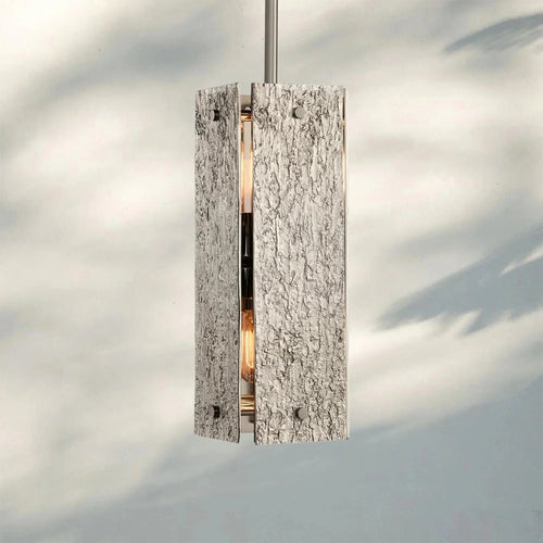 Monolith Pendant featuring a sculptural textured body with metallic detailing, a luxury Brutalist hanging light for modern interiors.