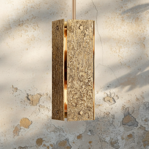 Monolith Pendant featuring a sculptural textured body with metallic detailing, a luxury Brutalist hanging light for modern interiors.