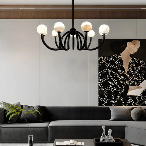 Modern living room with a chandelier, sofa, and wall art.