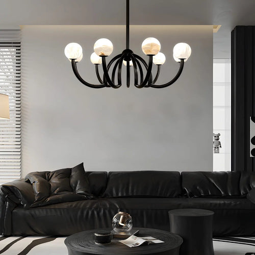 Modern living room with a black chandelier, black sofa, and coffee table.