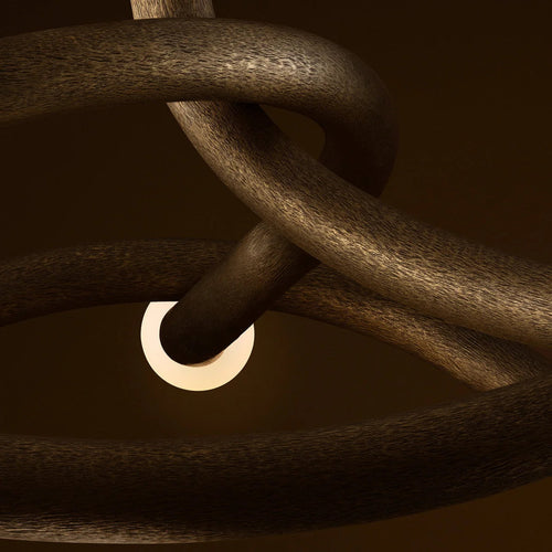 Seraphina Chandelier featuring a sculptural intertwined bronze frame with glass accents, a luxury Mid-Century modern statement light for sophisticated interiors