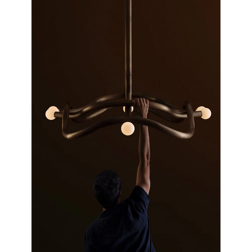 Seraphina Chandelier featuring a sculptural intertwined bronze frame with glass accents, a luxury Mid-Century modern statement light for sophisticated interiors