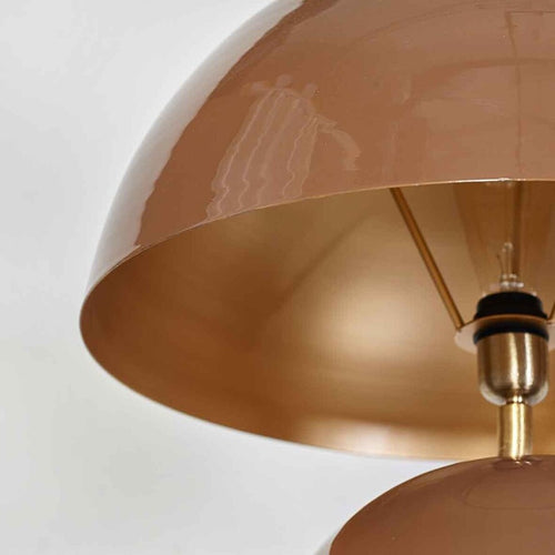 Sculptural brown metal floor lamp with stacked spherical base and dome shade in a modern minimalist interior.
