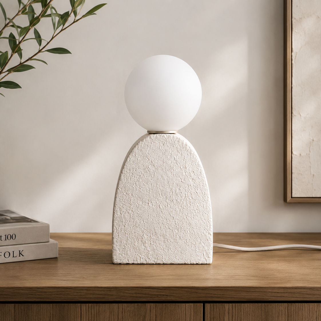 Terra Orb Table Lamp with a handcrafted textured ivory ceramic base and frosted glass globe, providing warm ambient lighting for Japandi and contemporary interiors