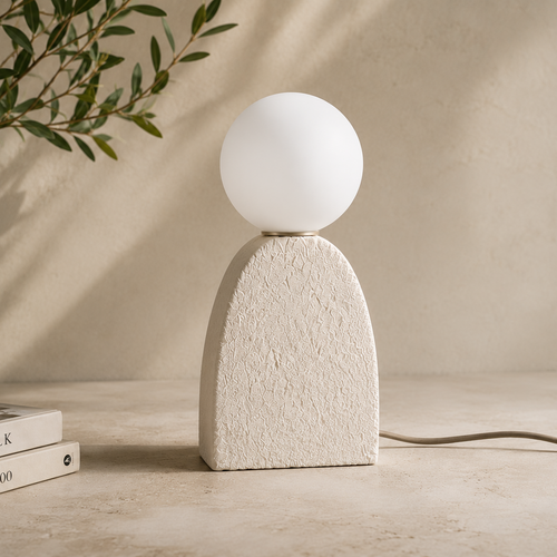 Terra Orb Table Lamp with a handcrafted textured ivory ceramic base and frosted glass globe, providing warm ambient lighting for Japandi and contemporary interiors