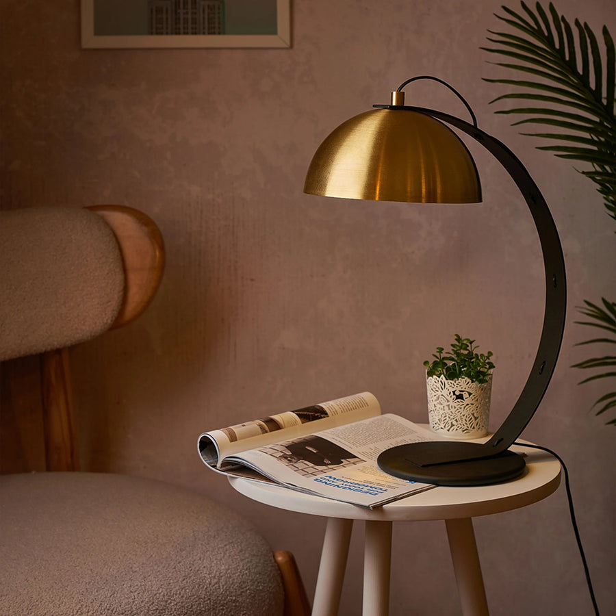 Valentino modern table lamp with brass dome shade on bedside table