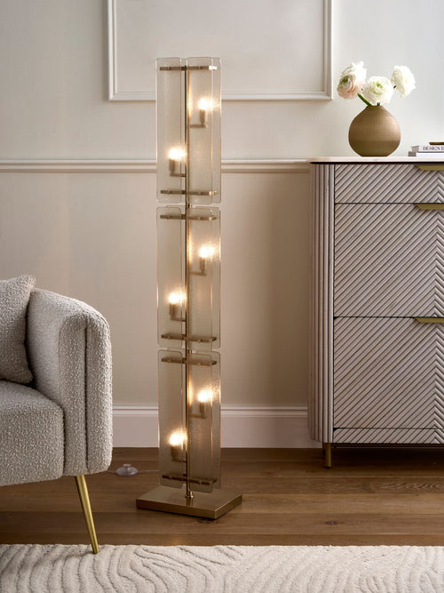 Vesper Floor Lamp featuring stacked textured glass panels and antique brass detailing, a luxury statement floor light for contemporary interiors