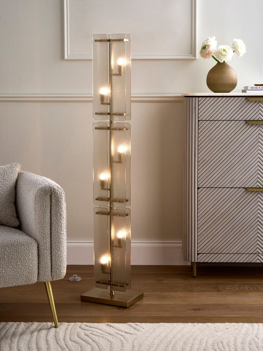 Vesper Floor Lamp featuring stacked textured glass panels and antique brass detailing, a luxury statement floor light for contemporary interiors