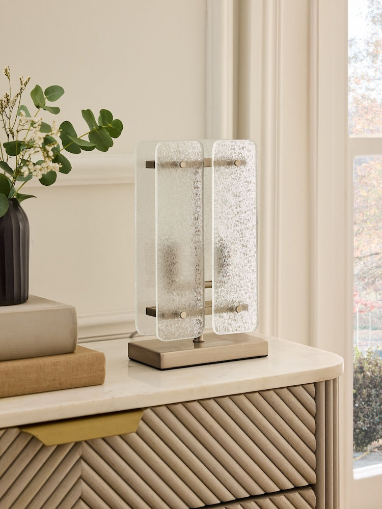 Vesper Table Lamp featuring textured glass panels and antique brass detailing, a luxury bedside and console lamp with warm ambient illumination