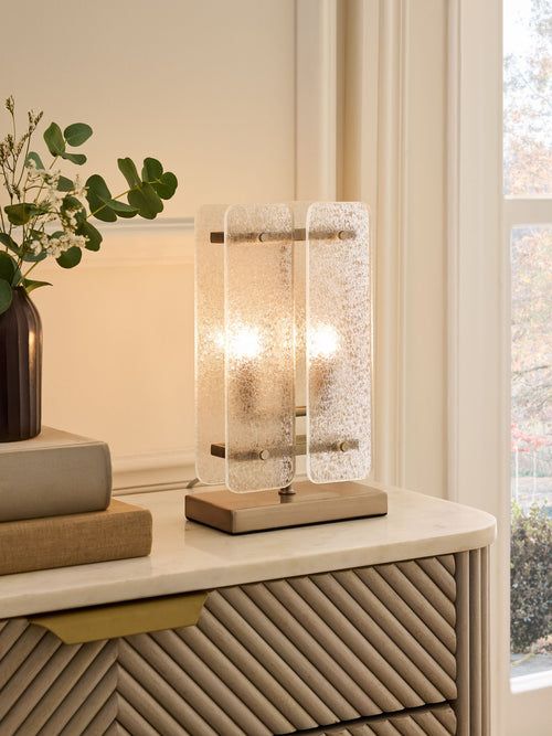 Vesper Table Lamp featuring textured glass panels and antique brass detailing, a luxury bedside and console lamp with warm ambient illumination