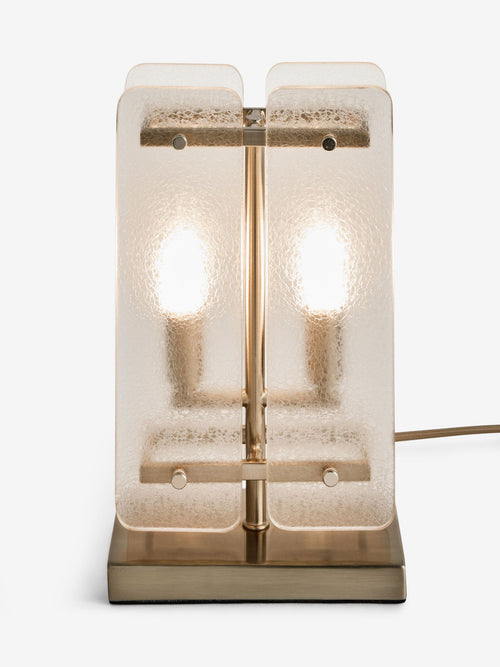 Vesper Table Lamp featuring textured glass panels and antique brass detailing, a luxury bedside and console lamp with warm ambient illumination