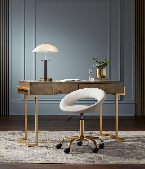 Liora gold and black glass table lamp with sculptural dome shade on console